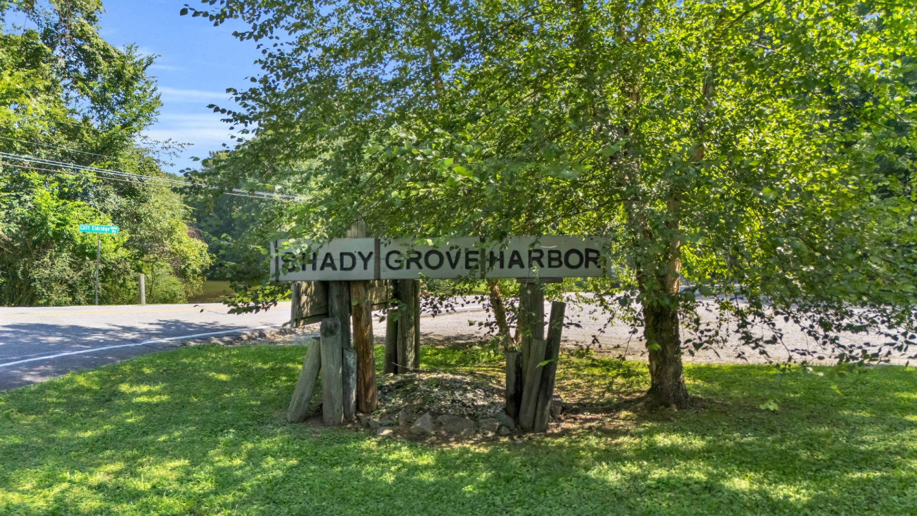 Weathered wooden Shady Grove Harbor entrance sign at the corner of Clift Eldridge Road.