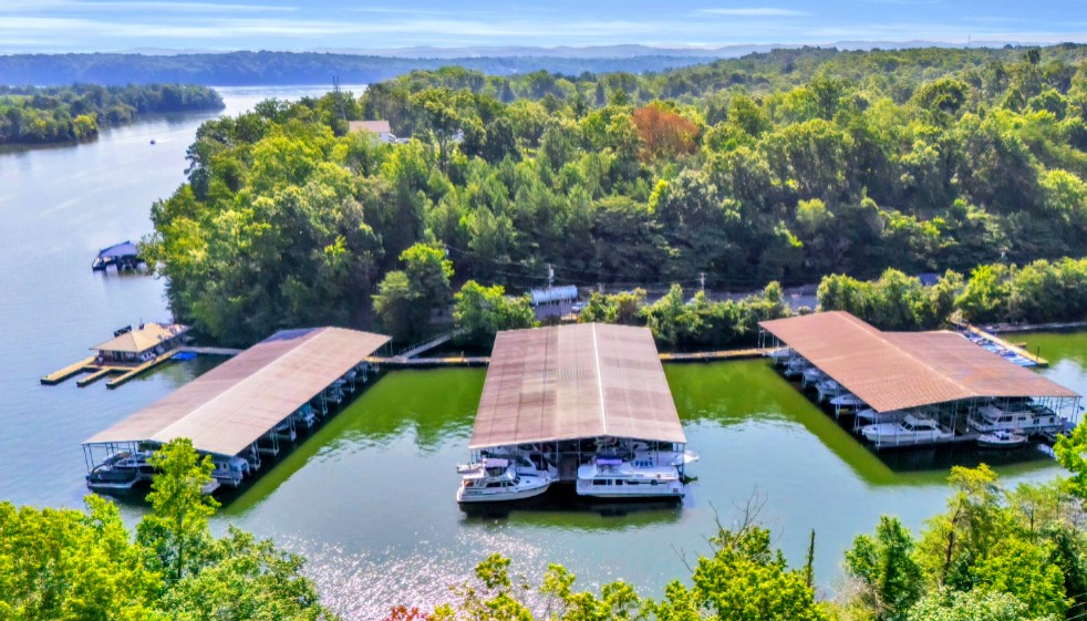 Aerial view of Shady Grove Harbor Marina showing three covered slip structures in a quiet cove.