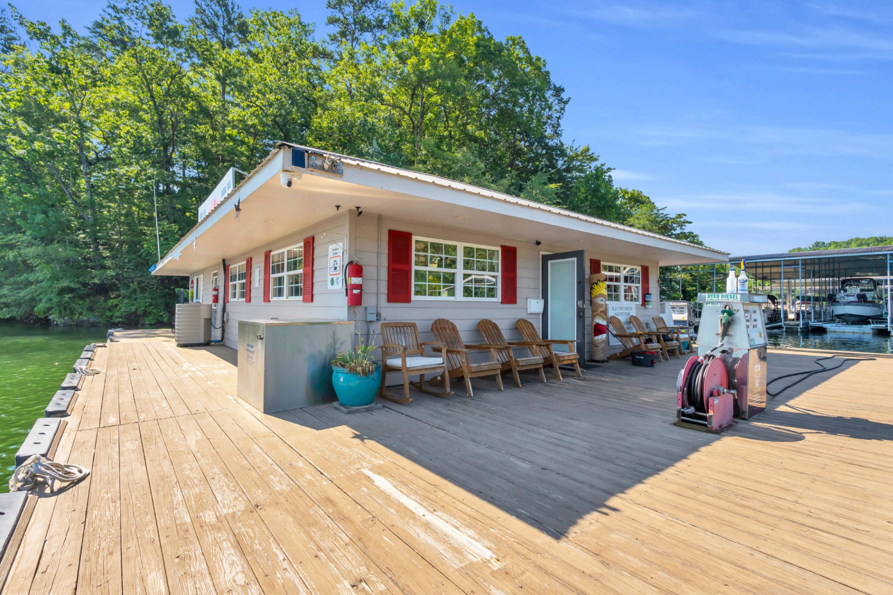 The floating marina store and fuel dock at Shady Grove Harbor with Adirondack chairs, fuel pump, and diesel reel on the deck.